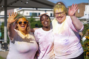 students in t shirts covered in coloured paint at the colour run