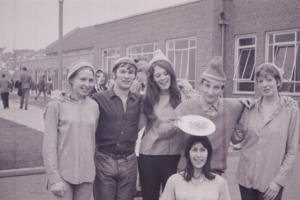 A group of people wearing hats outside the university in the 1960s