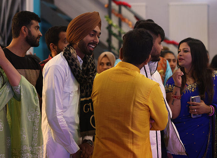 A group of male students are chatting at the Diwali celebrations
