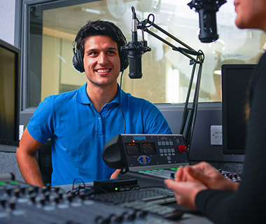 A male student in a recording studio